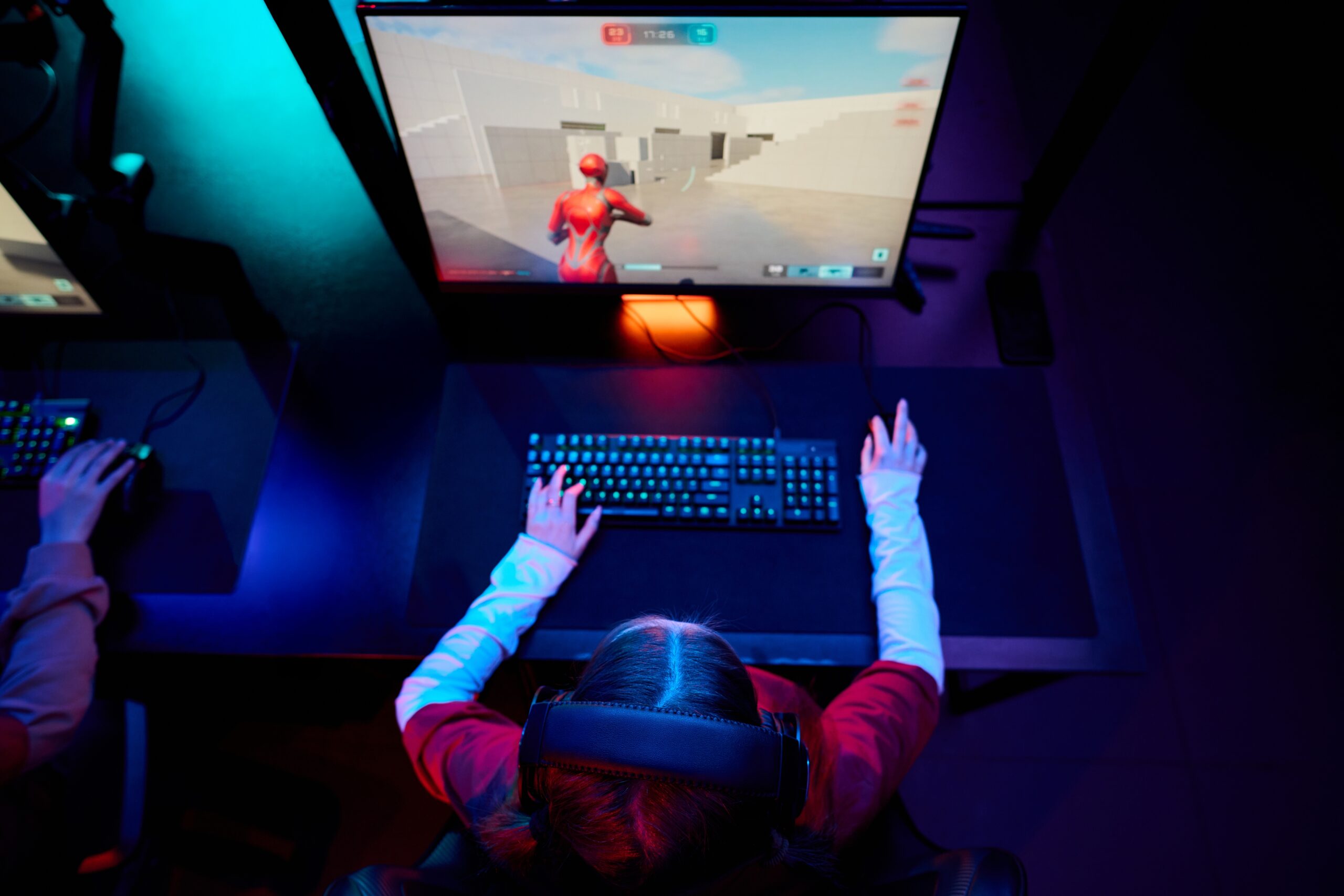 teenage,girl,gamer,sitting,at,desk,using,gaming,computer,and